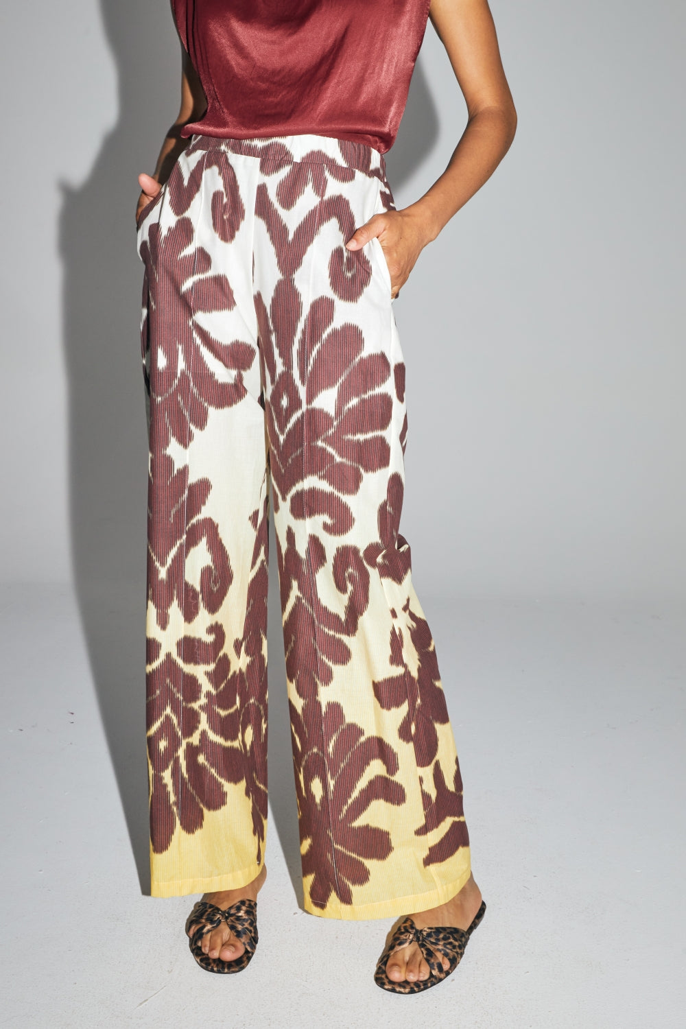 Pantalon imprimé Imprévu, modèle shadow porté par une femme en studio, vue de face avec mains dans les poches.