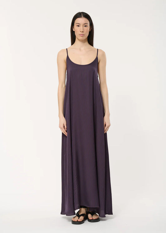Robe longue Bachira Humility, à fines bretelles, coupe fluide, tissu plissé à rayures verticales violet foncé.
